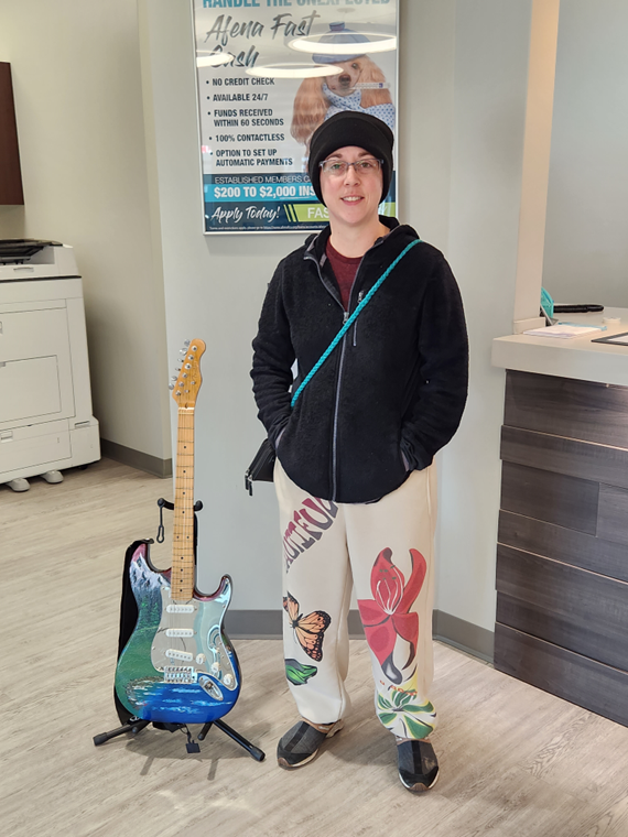 P. Brown Standing next to their new electric guitar